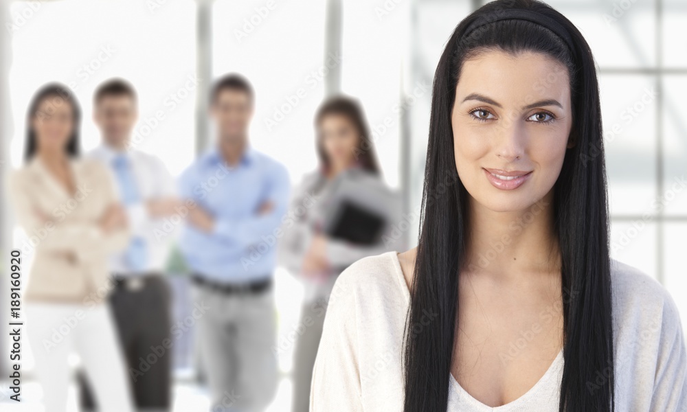Smiling young businesswoman and business team Smiling young businesswoman and business team