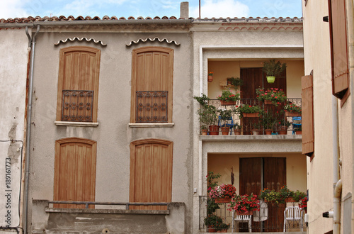 Stylish detail of french shutters and balconies, rural village square