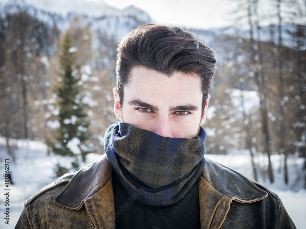 Portrait of adult handsome man covering face with scarf looking  provocatively at camera. Stock Photo | Adobe Stock
