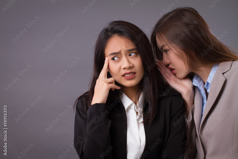 worried, frustrated business woman gossiping, spreading good news, secret, rumor worried, frustrated business woman gossiping, spreading good news, secret, rumor