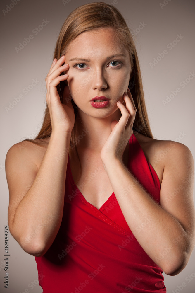 Moody studio portrait of a beautiful young brunette woman with long hair Moody studio portrait of a beautiful young brunette woman with long hair