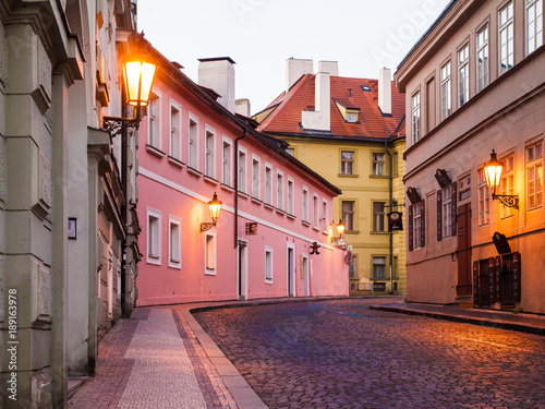 Prague early morning. Cobbled street with lamps and ancient houses. Czech Republic.