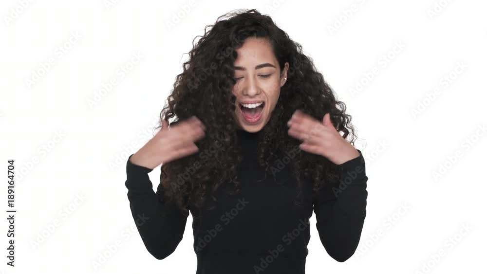 Portrait of cheerful woman being ecstatic rejoicing like winner being glad with good news over white background. Concept of emotions Portrait of cheerful woman being ecstatic rejoicing like winner being glad with good news over white background. Concept of emotions