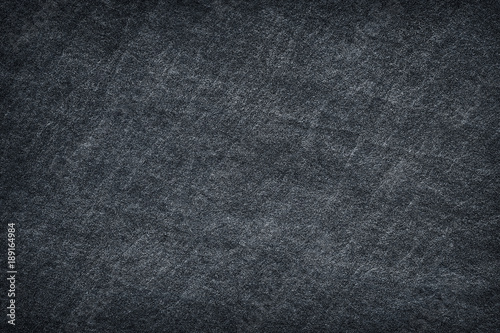 Dark grey black slate stone abstract background or texture