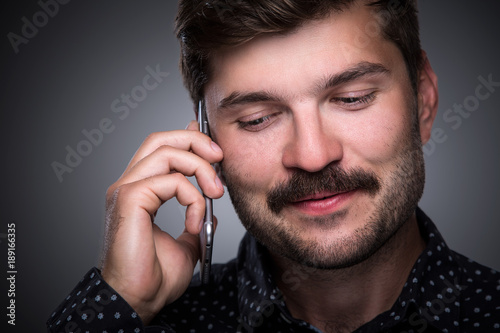 Handsome businessman speaks on the phone