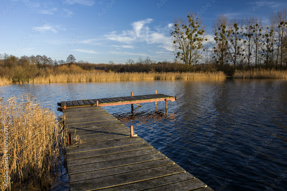 Wooden jetty and lake in autumn