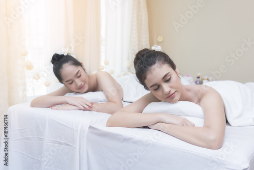 Beautiful Asian young women lying on massage table waiting for spa treatment
