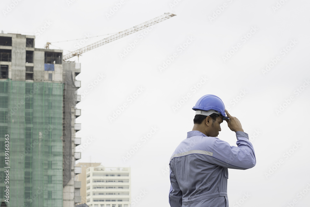 engineer or foreman holding hard cap on construction site engineer or foreman holding hard cap on construction site