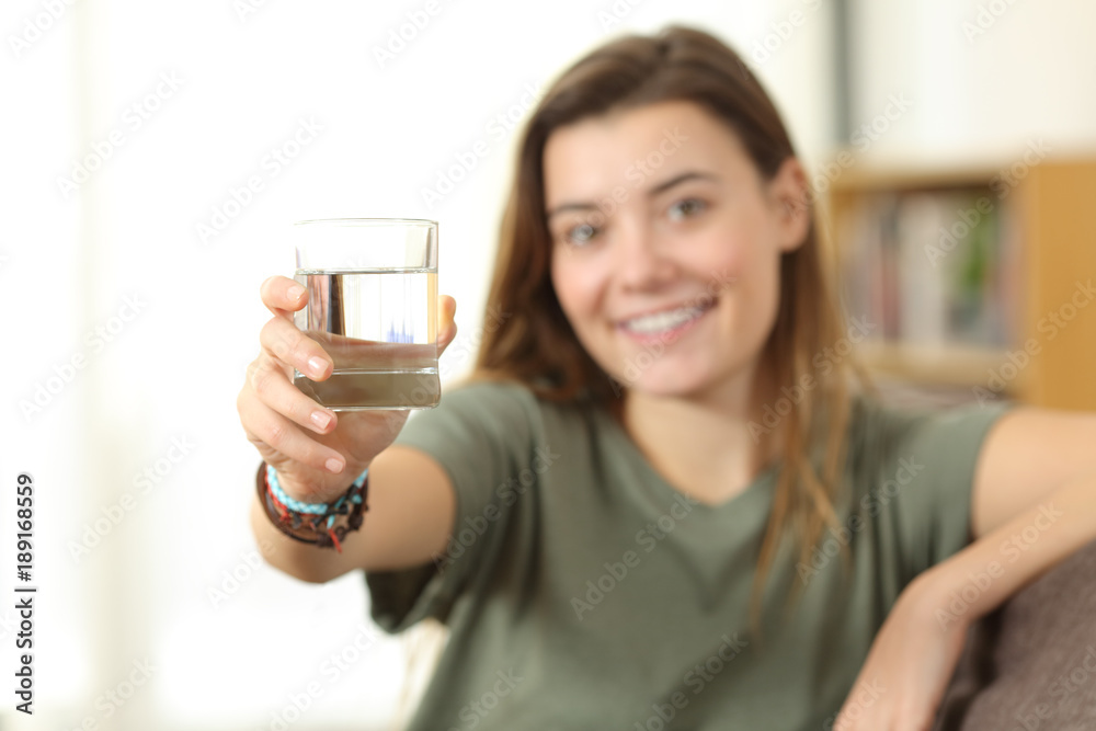 Healthy teen showing a glass of water Healthy teen showing a glass of water