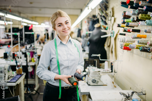 Clothes designer with color threads in hands