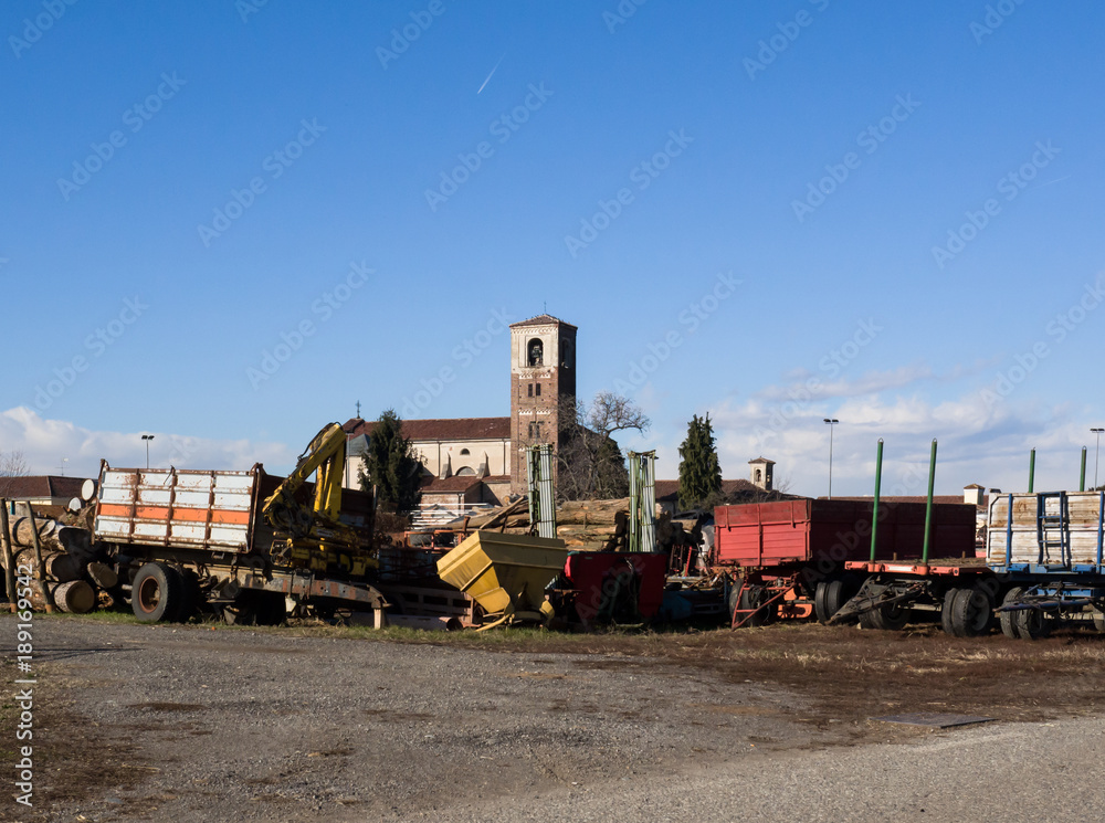 blue sky on farm storage, in the background the old church of the village