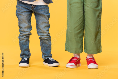 partial view of kids in casual clothing isolated on yellow