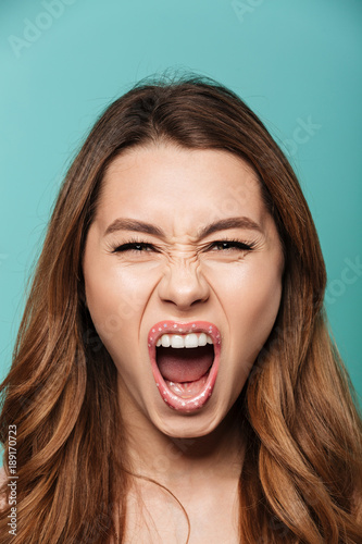Beauty portrait of a furious brown haired woman