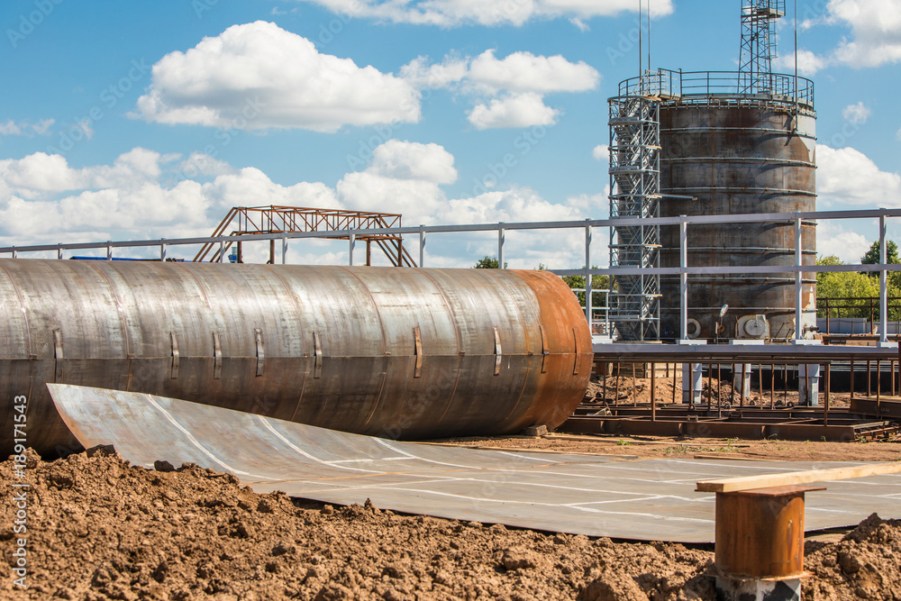 Construction of an oil tank, oil deposit on the background. Construction of an oil tank, oil deposit on the background.