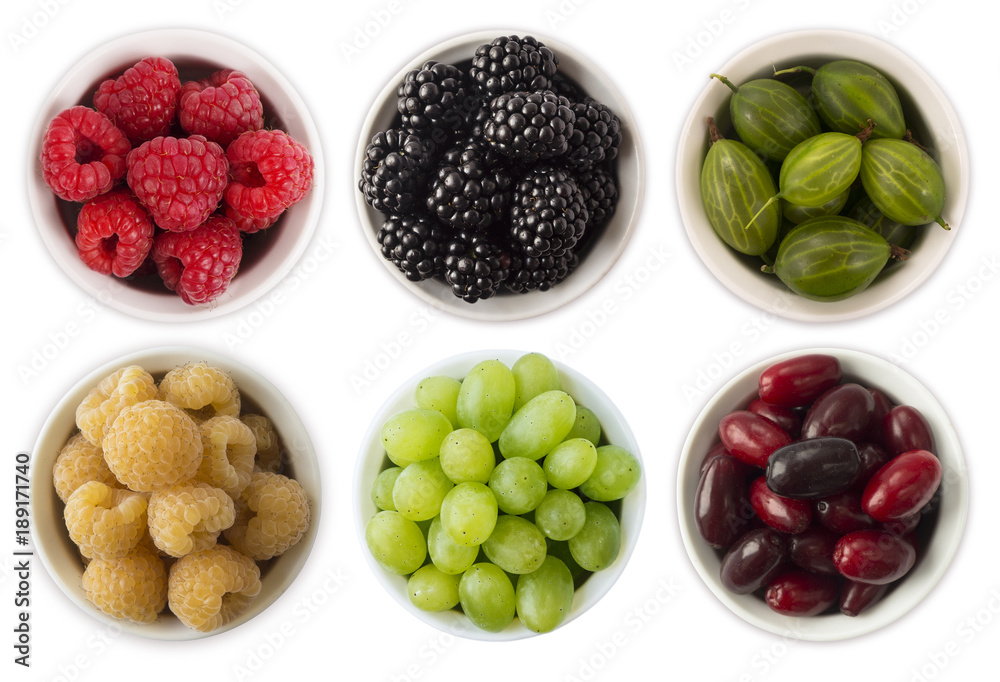 Fruits and berries in bowl isolated on white. Sweet and juicy berry with copy space for text. Rasberries, blackberries, gooseberries and grapes. Collage of different fruits and berries. Top view. Fruits and berries in bowl isolated on white. Sweet and juicy berry with copy space for text. Rasberries, blackberries, gooseberries and grapes. Collage of different fruits and berries. Top view.