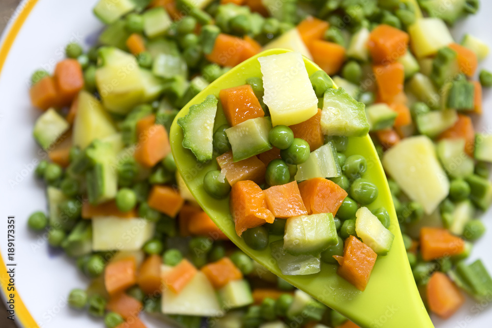 chopped vegetables on a spatula chopped vegetables on a spatula