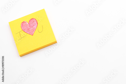 Paper red heart on Yellow Post-it note with White Pastel plastic texture background. Valentine concept. Minimal concept