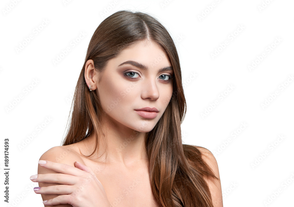 Fullface half profile portrait of beautiful green-eyed brunette model with makeup on, including nude lipstick, light brown eyeshadows and mascara. Made on white background isolated in photo studio. Fullface half profile portrait of beautiful green-eyed brunette model with makeup on, including nude lipstick, light brown eyeshadows and mascara. Made on white background isolated in photo studio.