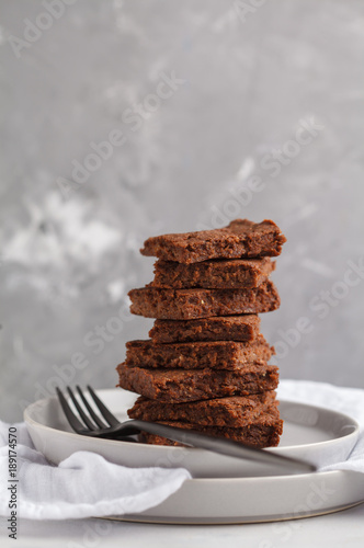 A stack of slices of healthy vegan brownies. Healthy dietary vegan dessert concept. Copy space