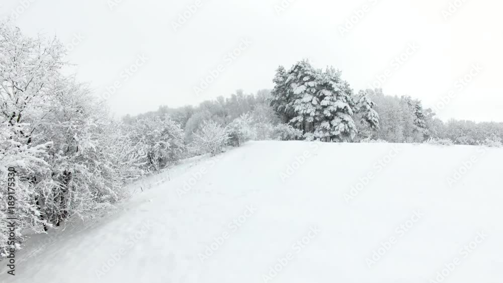 Aerial: Snow-covered countryside in winter Aerial: Snow-covered countryside in winter