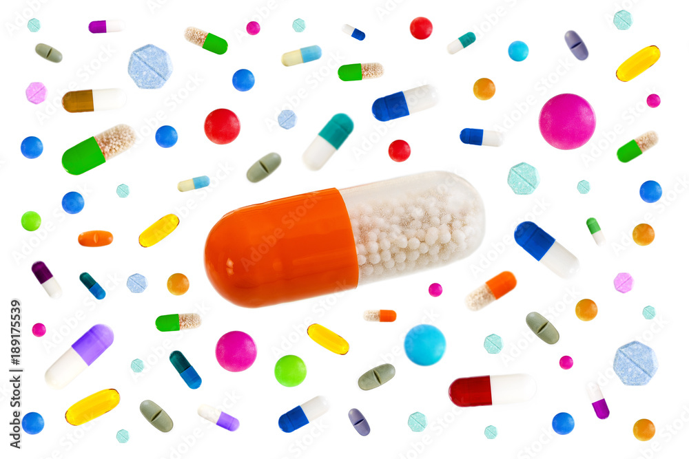 Symbol image of drugs danger : Many colorful medicines Pills and capsules with in the middle a big one on white background Symbol image of drugs danger : Many colorful medicines Pills and capsules with in the middle a big one on white background