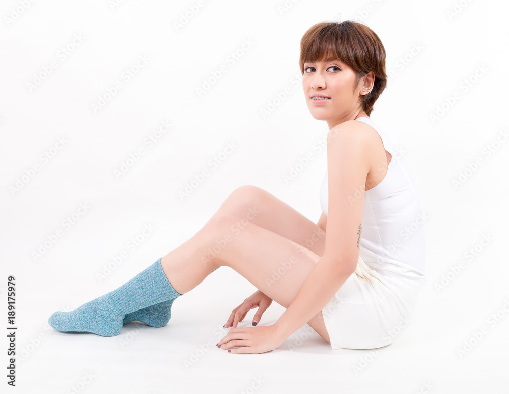 Fototapeta premium Blue cotton socks on beautiful woman's feet. Isolated on white background. Studio lighting
