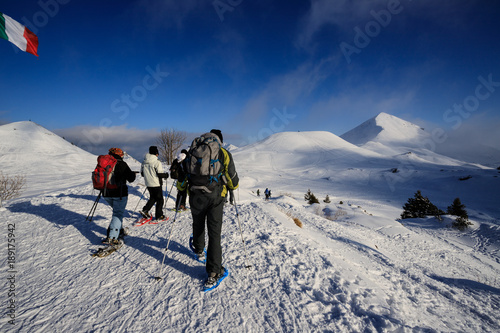 alpinisti che scendono dalla cima di Piazzo. Sullo sfondo mi monte Sodadura - alpi Orobie photo