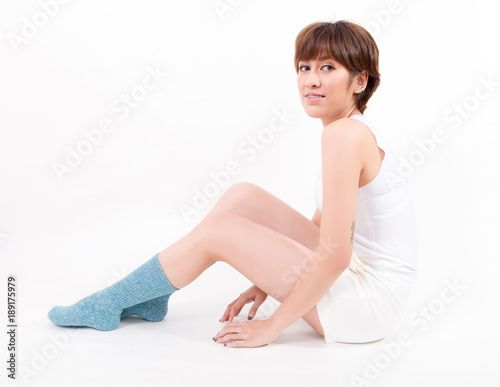 Blue cotton socks on beautiful woman's feet. Isolated on white background. Studio lighting