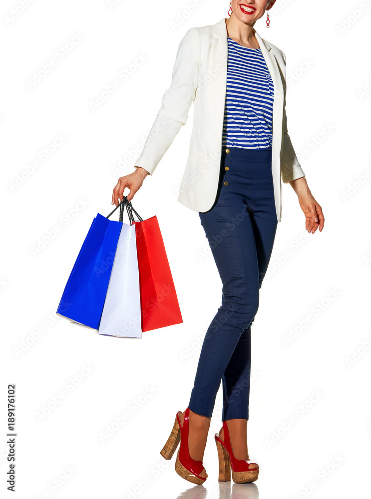happy woman with shopping bags on white looking at copy space
