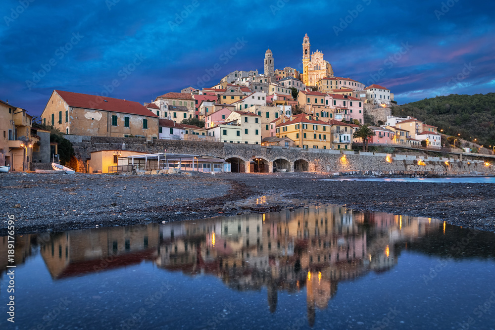 Old ligurian town Cervo reflecting in water at dusk, Province of Imperia, Liguria, Italy