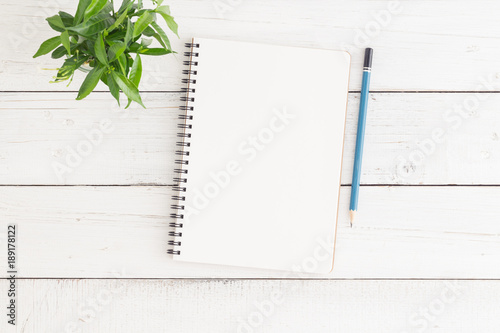 Empty open notebook on white wood table top view