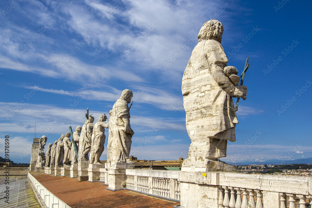 Eleven statues of the saints apostles standing on the roof of Saint Peter's Basilica  in Vatican City, Rome, Italy, back view
