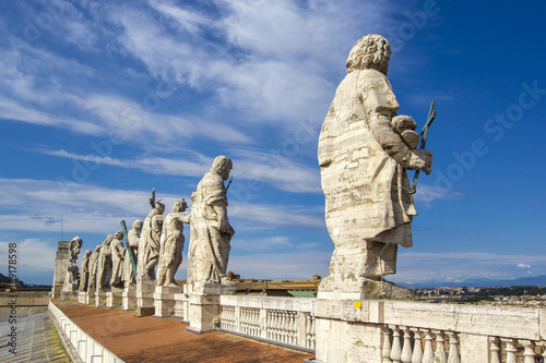 Eleven statues of the saints apostles standing on the roof of Saint Peter's Basilica in Vatican City, Rome, Italy, back view