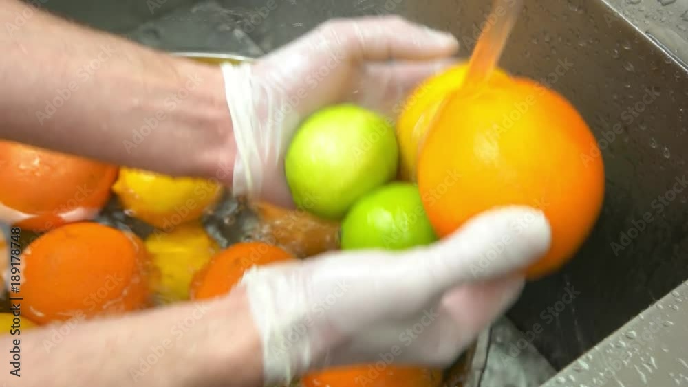 Hands washing citrus fruits. Orange, lime and lemon. Hands washing citrus fruits. Orange, lime and lemon.