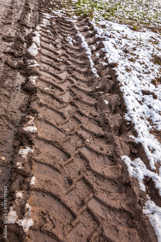 Tire track in the muddy ground Tire track in the muddy ground