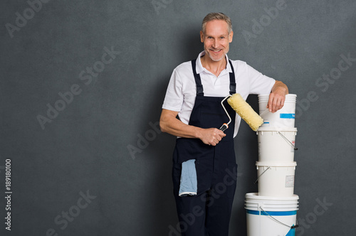Happy painter holding roller