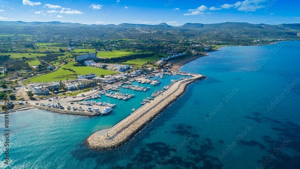 Aerial bird's eye view of Latchi port,  Akamas peninsula, Polis Chrysochous, Paphos,Cyprus. Latsi harbour with boats and yachts, fish restaurant, promenade, beach tourist area and mountains from above