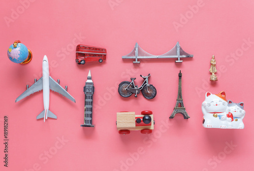 Flat lay aerial image of travel background concept.Table top view of souvenir symbol location or landmark of place for traveler all the world.objects on modern rustic pink paper.mock up & template. photo