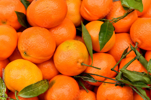 Tangerines are sold on the market. Texture of mandarin. Harvest of citrus fruits.