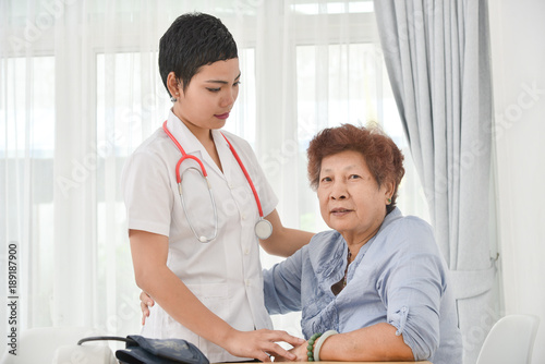 Health care worker helping an elderly patient