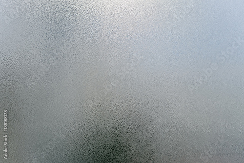 Window transparent blurred foggy glass with condensated water drops monochrome background. Vibrant freshness simplicity texture, season mood image