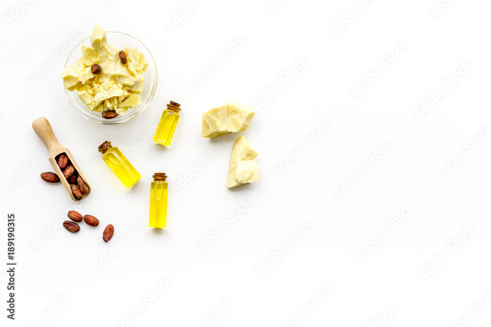 Cocoa butter for skin care. White background top view copy space Cocoa butter for skin care. White background top view copy space