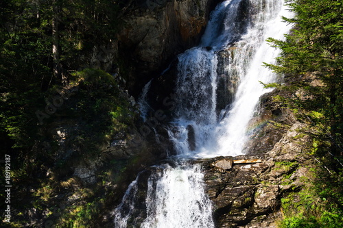Alpine waterfall Riesachwasserfall from lake Riesachsee near Schladming in Austria