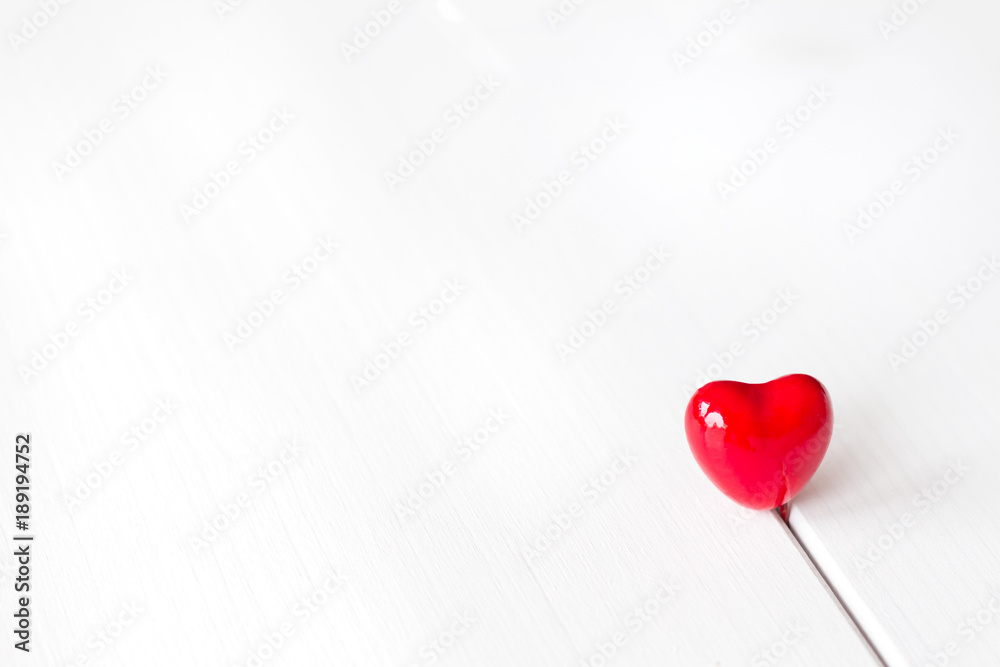 Red heart on white wooden background. Valentines day wallpaper.