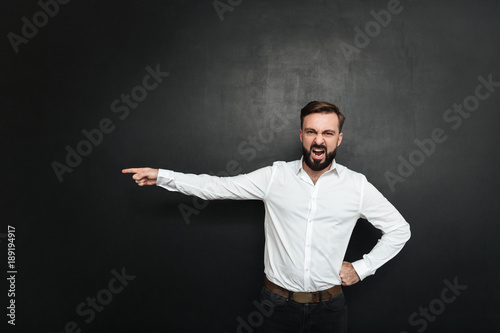 Foto Picture of angry male employer screaming in outrage and pointing finger at door