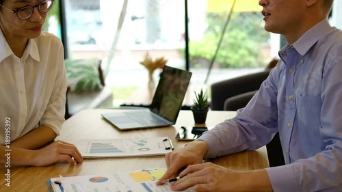 businessman & businesswoman working at workplace. startup man & woman having discussion in office. Business people shaking hands after finishing up a meeting. Two colleagues handshaking after conferen photo