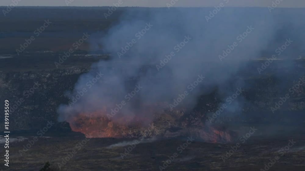 Smoke and steam rise from a volcanic crater Smoke and steam rise from a volcanic crater