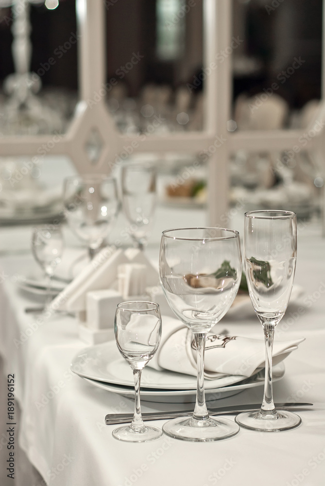 Glass dishes on a table on a white tablecloth Glass dishes on a table on a white tablecloth