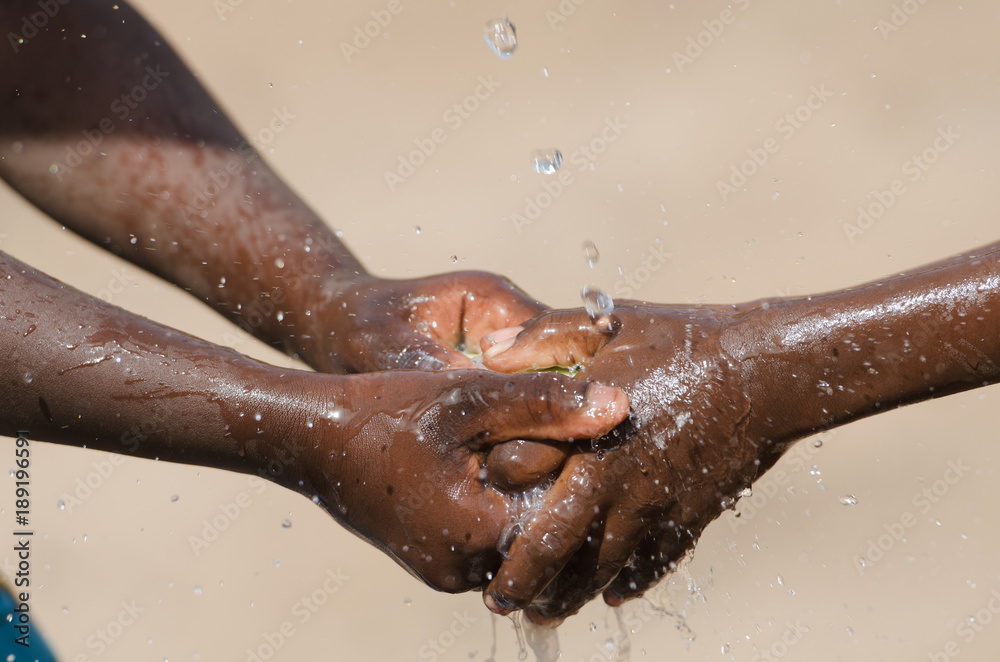 Fototapeta premium Water Issues in Africa - Black Children Washing Hands