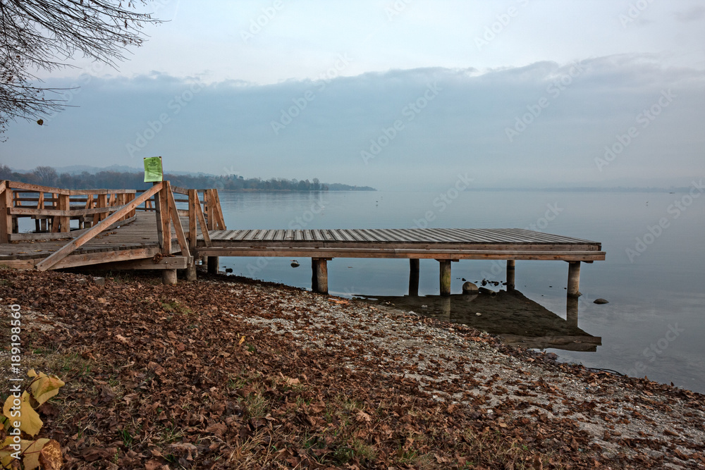 Wooden dock for mooring boats, by the lake.